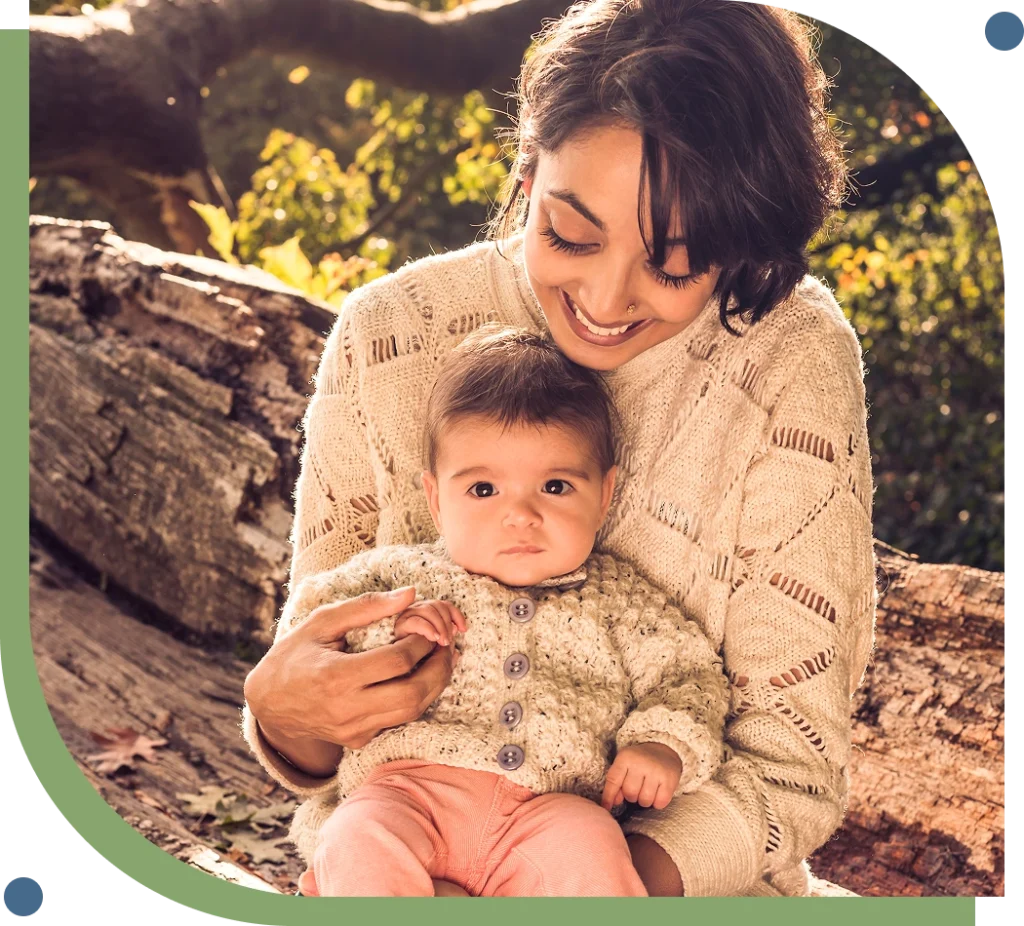 Mother holding baby representing perinatal and postpartum mental health care at New Leaf Mental Health